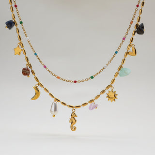 Boho celestial layered gold necklace with moon, star & seahorse charms, gemstones & pearl. 18K gold-plated. Perfect for bohemian style & everyday elegance.
