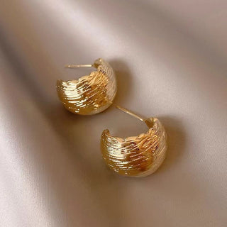Modern textured wave hoop earrings in gold or silver. Lightweight sculptural design. Perfect for everyday elegance & office style.