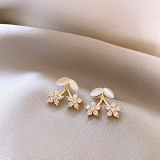 Delicate gold flower stud earrings with opal petals & cubic zirconia. Lightweight, romantic design. Perfect for everyday elegance & feminine style.
