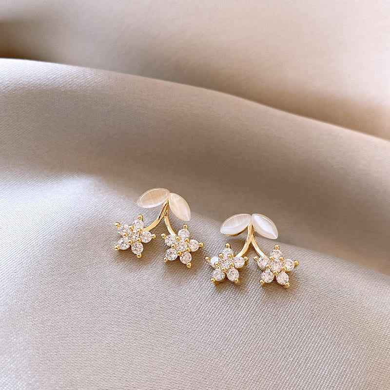 Delicate gold flower stud earrings with opal petals & cubic zirconia. Lightweight, romantic design. Perfect for everyday elegance & feminine style.