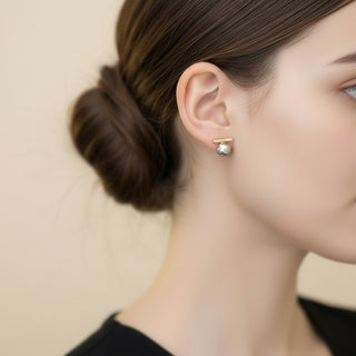 Modern gold bar stud earrings with gray pearls. Lightweight minimalist design. Perfect for office sophistication & everyday elegance.