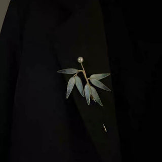 Elegant bamboo leaf brooch with translucent blue-gray leaves & lustrous pearl. Handcrafted minimalist design inspired by Eastern aesthetics. Perfect for Hanfu, blazers & scarves.