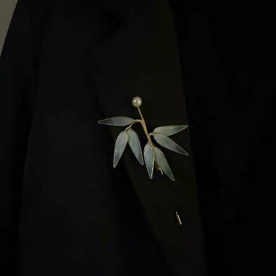 Elegant bamboo leaf brooch with translucent blue-gray leaves & lustrous pearl. Handcrafted minimalist design inspired by Eastern aesthetics. Perfect for Hanfu, blazers & scarves.