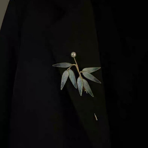 Elegant bamboo leaf brooch with translucent blue-gray leaves & lustrous pearl. Handcrafted minimalist design inspired by Eastern aesthetics. Perfect for Hanfu, blazers & scarves.