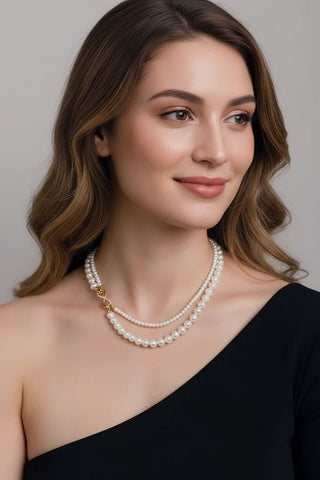 Elegant dual-strand pearl necklace with gold infinity clasp. Wear together or separately. Versatile layered design perfect for everyday elegance & special occasions.